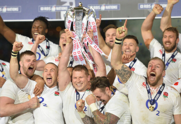 Dylan Hartley, surrounded by England teammates, lifts the 2016 Six Nations trophy
