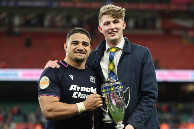 Scotland captain Sione Tuipulotu receives the Doddie Weir Cup from Hamish Weir in 2026