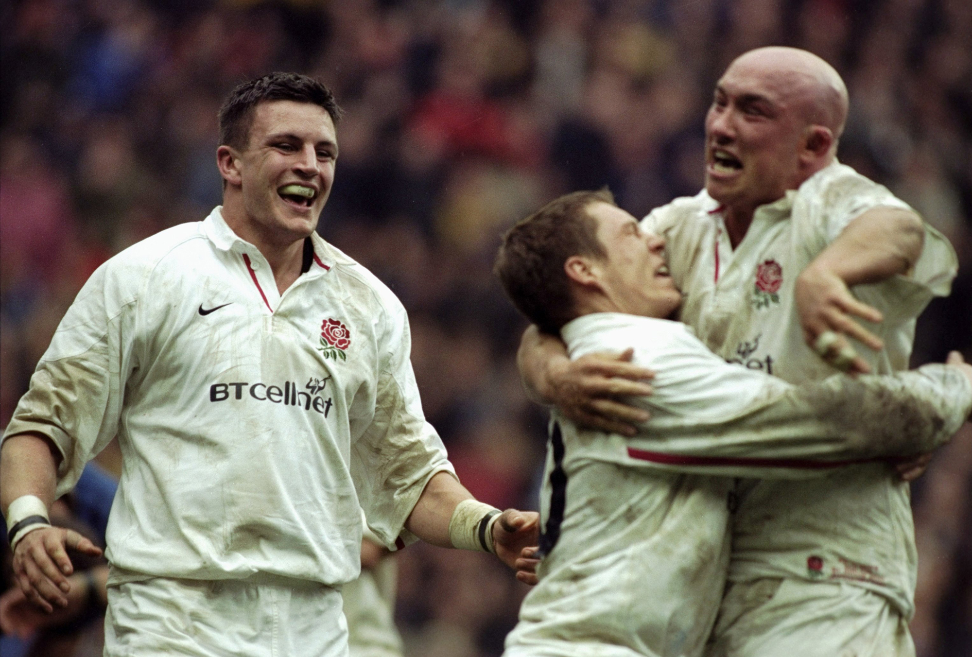 Martin Corry looks on as Jonny Wilkinson and Phil Greening celebrate victory for England during the Six Nations Championship match against France played at the Stade de France in 2000