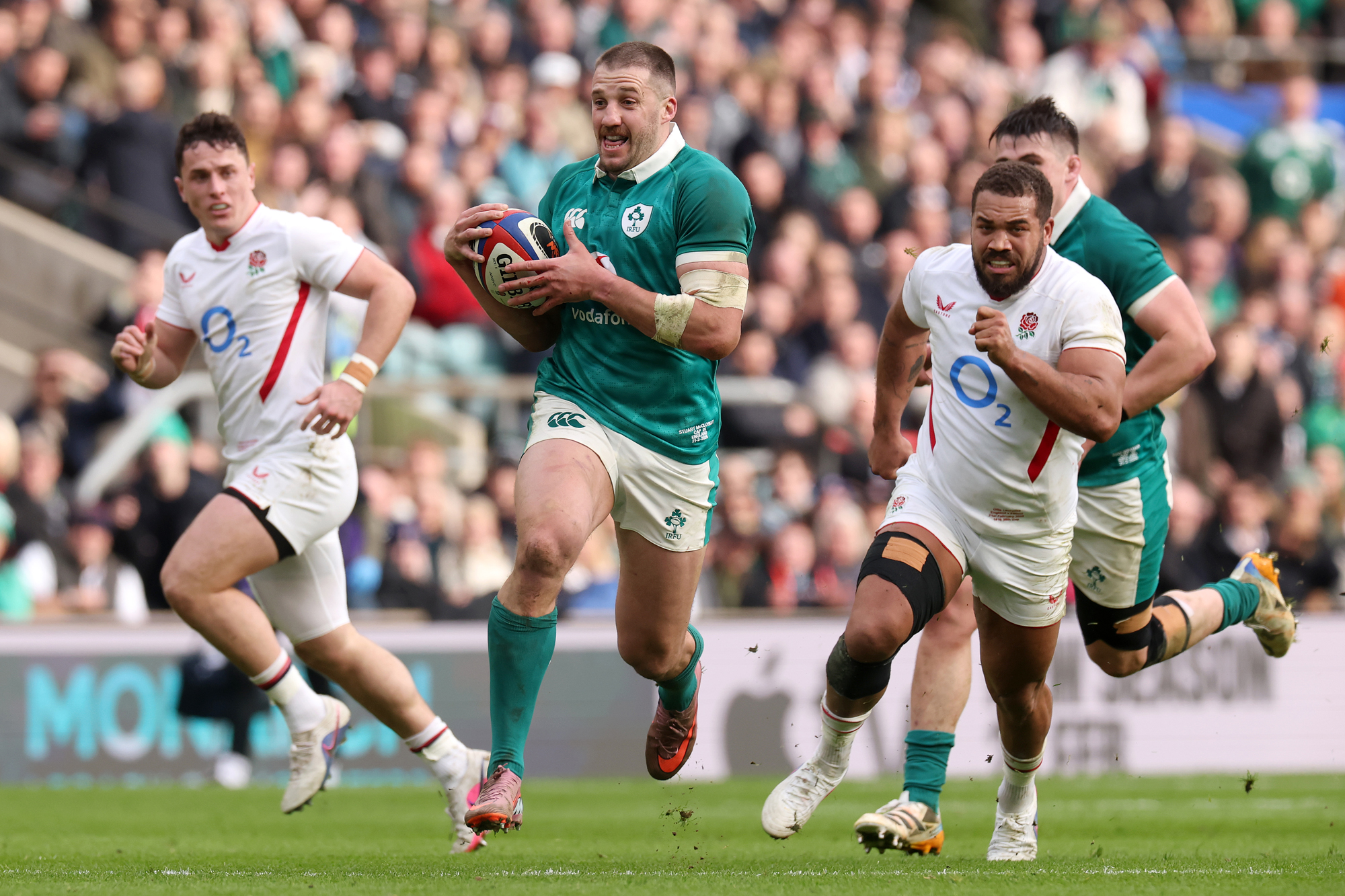 Stuart McCloskey of Ireland runs with the ball while England’s Ollie Lawrence chases during the 2026 Six Nations match