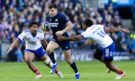 Scotland's Blair Kinghorn runs past French tacklers during the March 2026 Six Nations match.