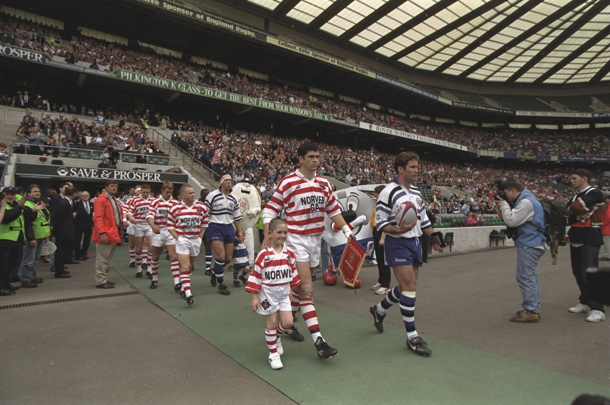 Bath and Wigan players walk out onto the pitch ahead of the rugby union leg of the Clash of the Codes in May 1996.