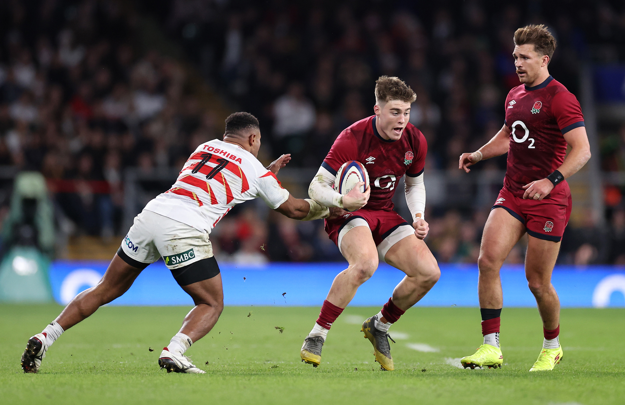 England's Tommy Freeman evades a Japan player's tackle during the November 2024 international.