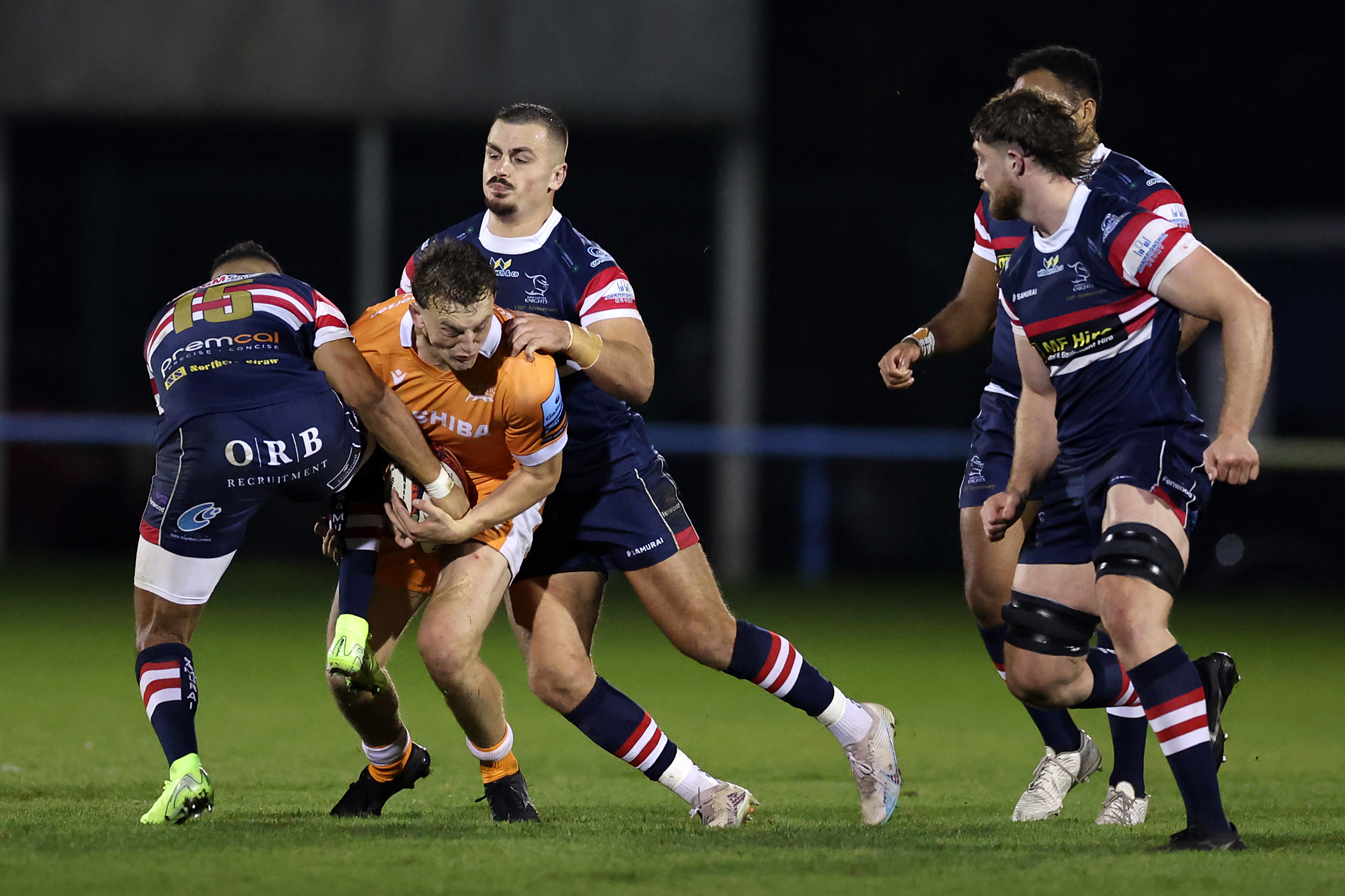 Joe Bedlow of Sale Sharks is tackled by Telusa Veainu of Doncaster Knights during the Premiership Rugby Cup match between Doncaster Knights and Sale Sharks in November 2024