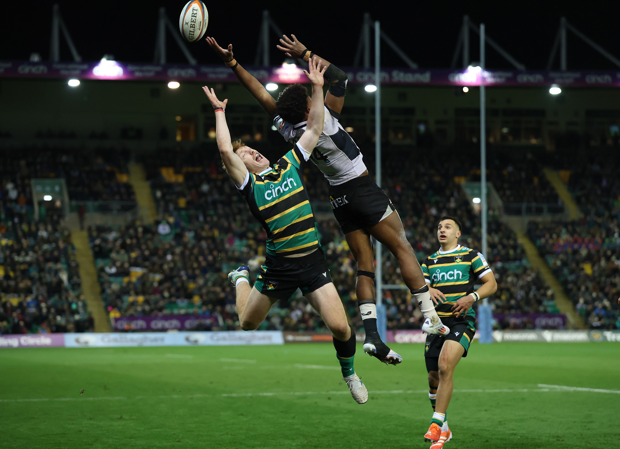 Saracens' Noah Caluori jumps with the ball against Northampton Saints' George Hendy during the October 2025 Gallagher PREM match.
