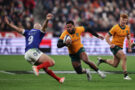 Australia's Filipo Daugunu tries to evade France's Maxime Lucu during the November 2025 Autumn Nations Series match in Paris