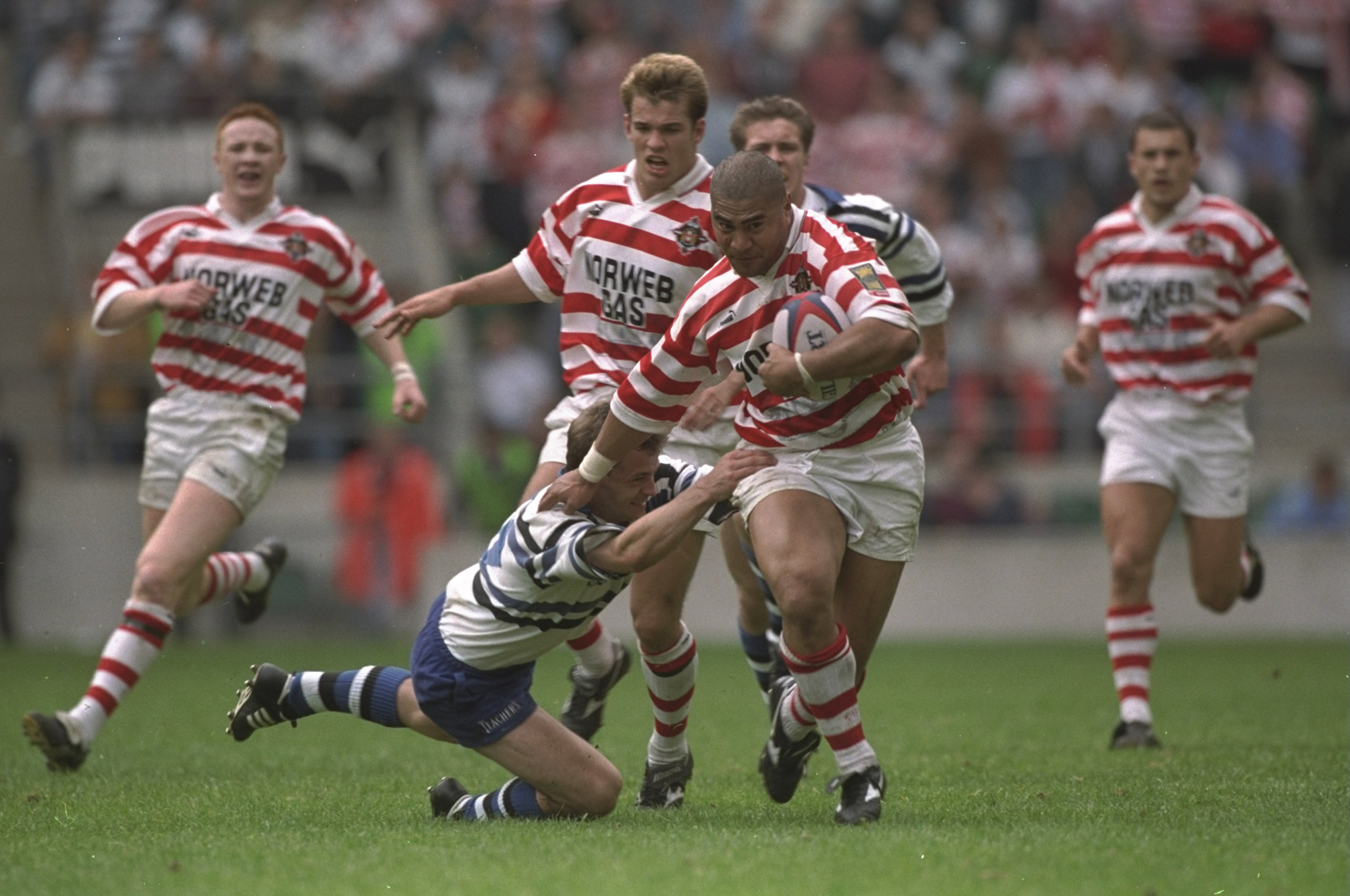 Va''aiga Tuigamala of Wigan breaks a Bath tackle during the rugby union leg of the 1996 Clash of the Codes