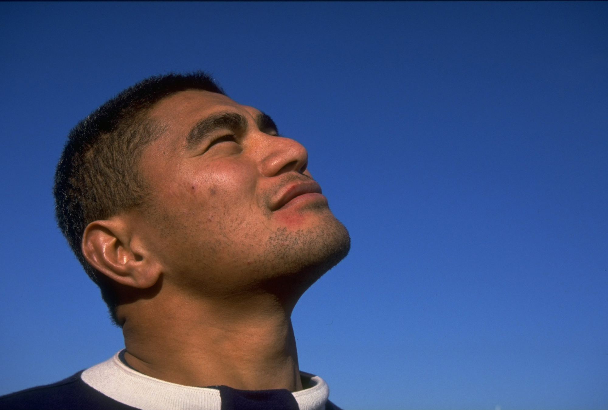 A portrait of Va'aiga Tuigamala looking to the sky ahead of the All Blacks' 1993 Test series against the British & Irish Lions.