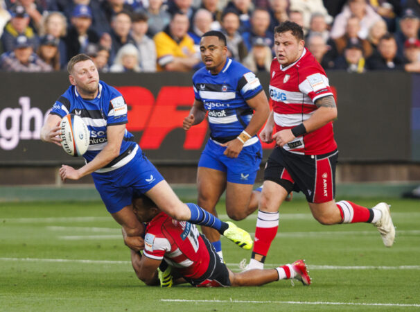 Bath’s Finn Russell passes the ball under pressure from Gloucester during the October 2025 Gallagher PREM match.
