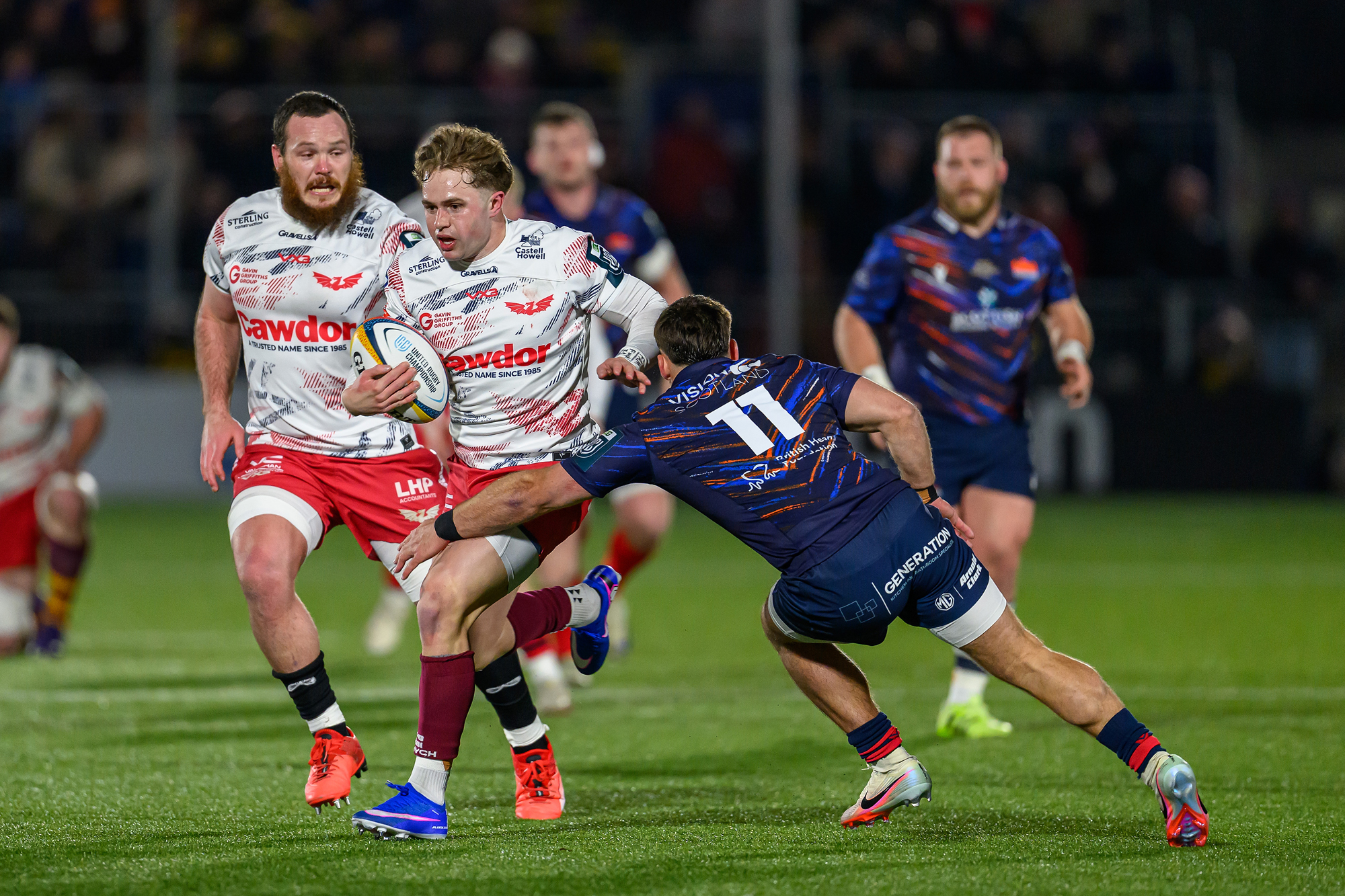 Scarlets' Macs Page attempts to break a tackle during the February 2026 URC match against Edinburgh