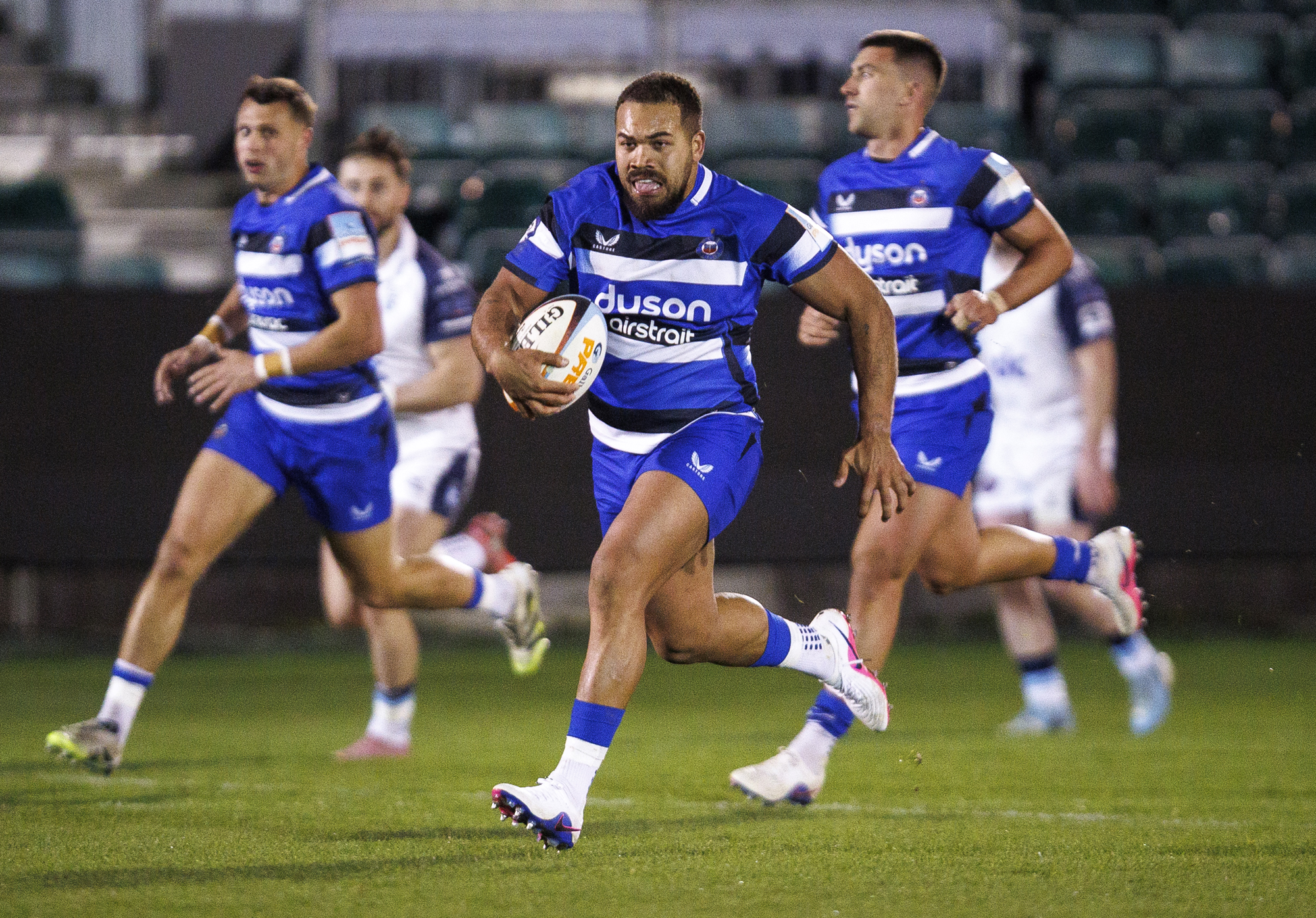 Ollie Lawrence of Bath runs with the ball during a March 2026 friendly against Bedford Blues