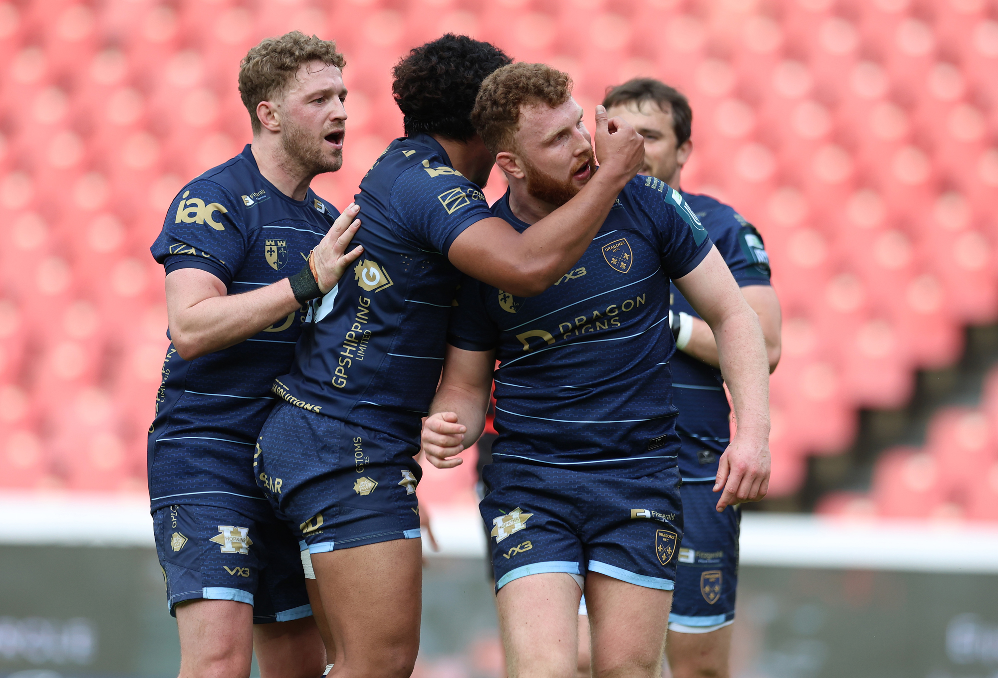 Dragons’ Aneurin Owen celebrates scoring a try with his teammates during a 2026 URC match against the Lions.
