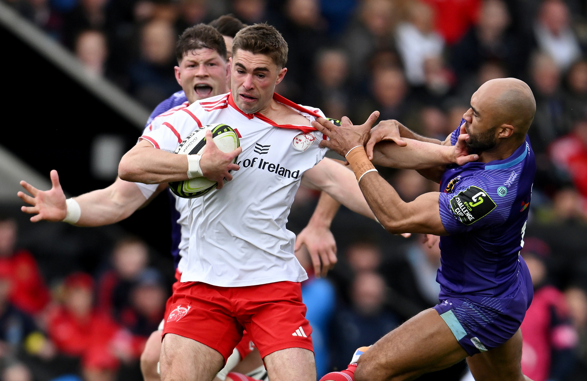 Munster's Jack Crowley is tackled by Exeter's Olly Woodburn during the April 2026 Challenge CUp match
