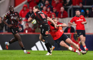 Lions' Chris Smith is tackled by Munster's Mike Haley during a May 2026 URC encounter.