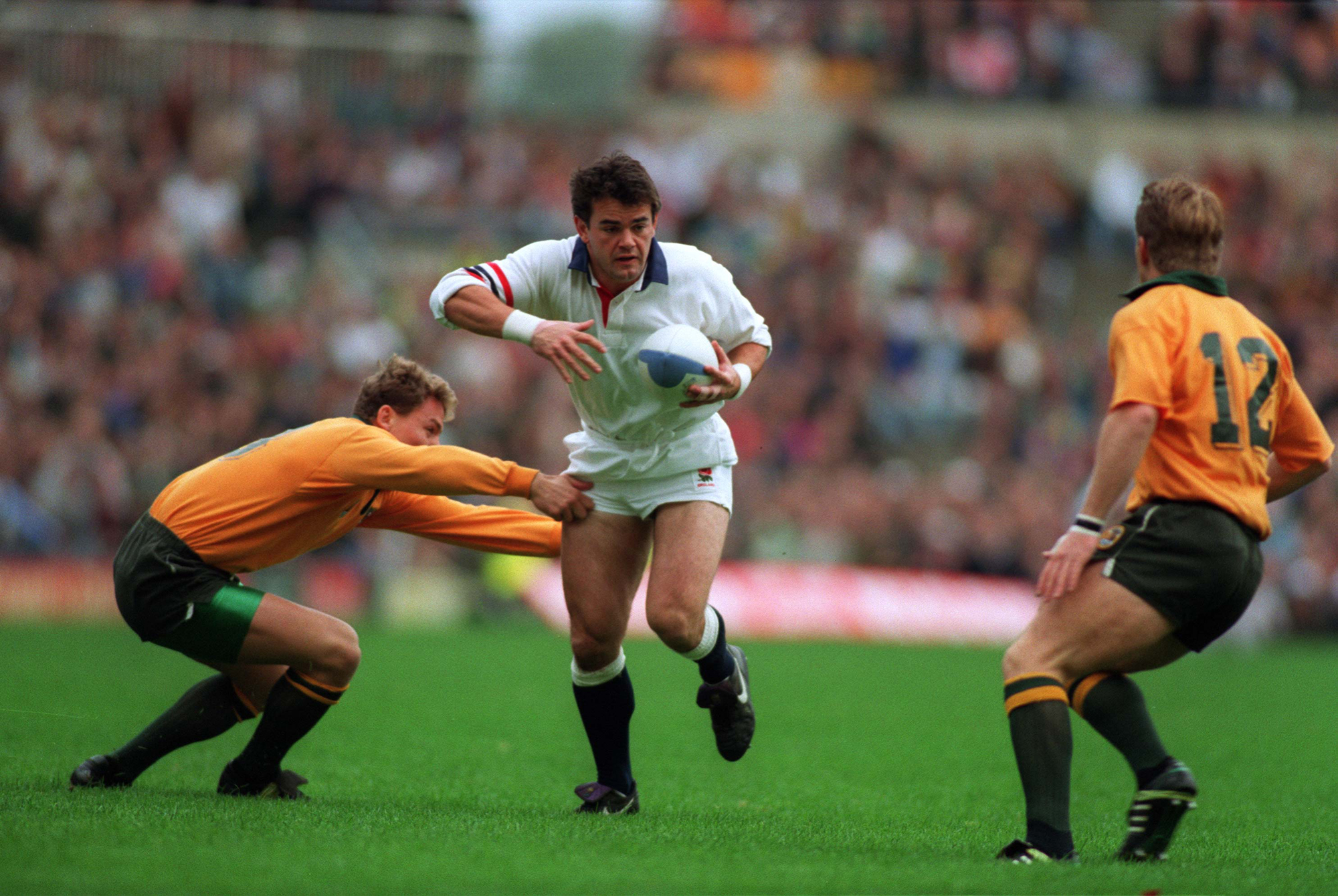 England's Will Carling runs through a tackle from Australia's Jason Little during the 1991 World Cup final