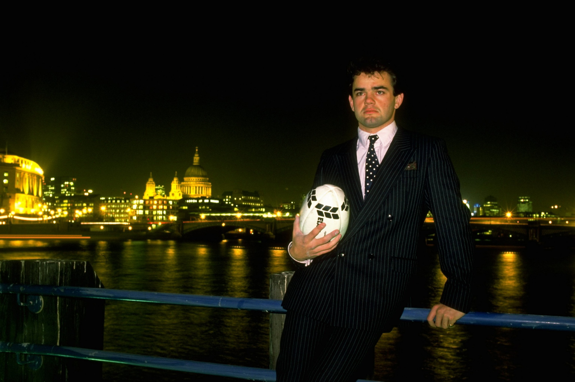 Will Carling photographed in a suit in front of the Thames after becoming England rugby captain in 1988