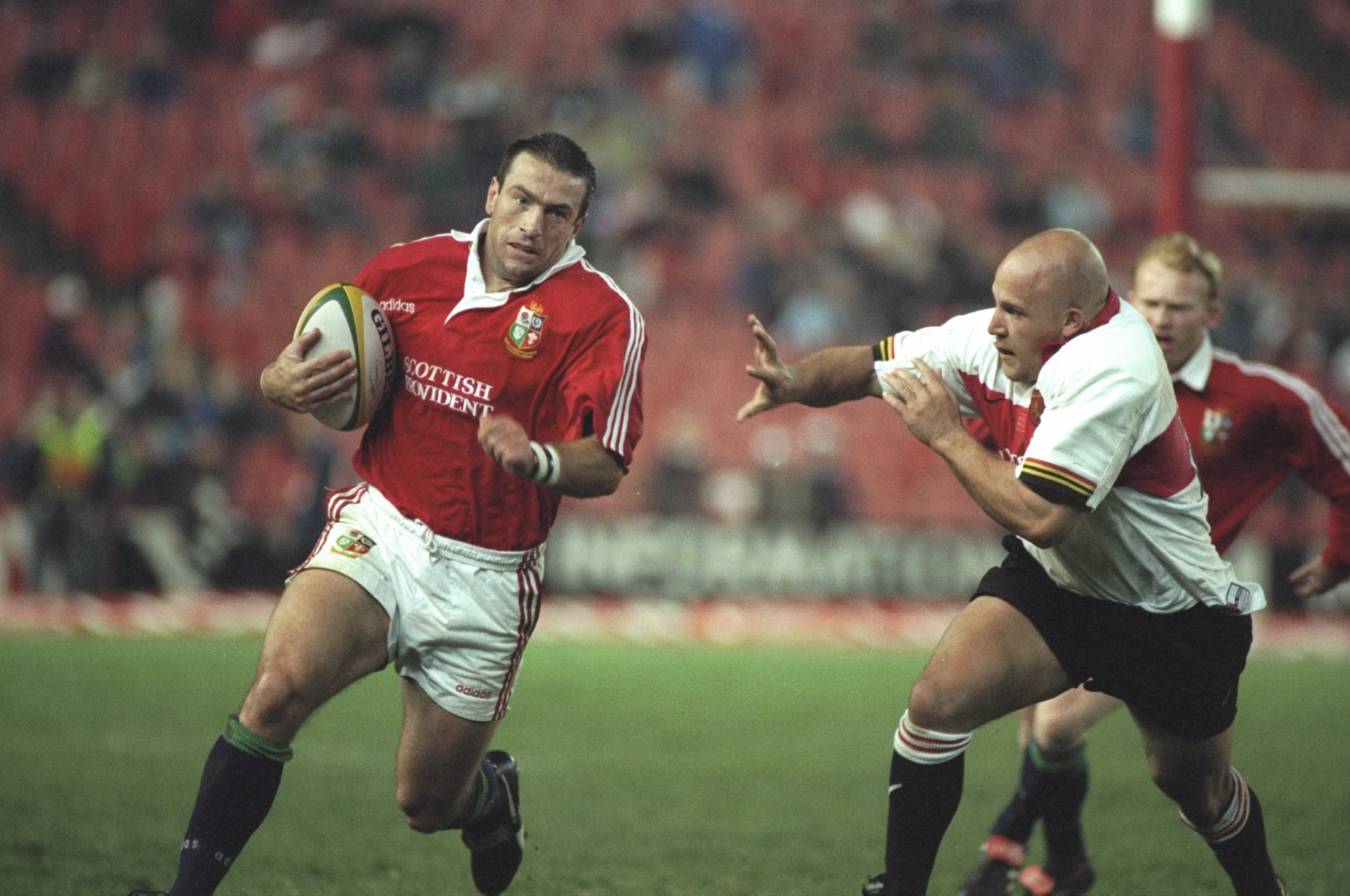 John Bentley of the British & Irish Lions runs past the Guateng defenders during the 1997 tour of South Africa.