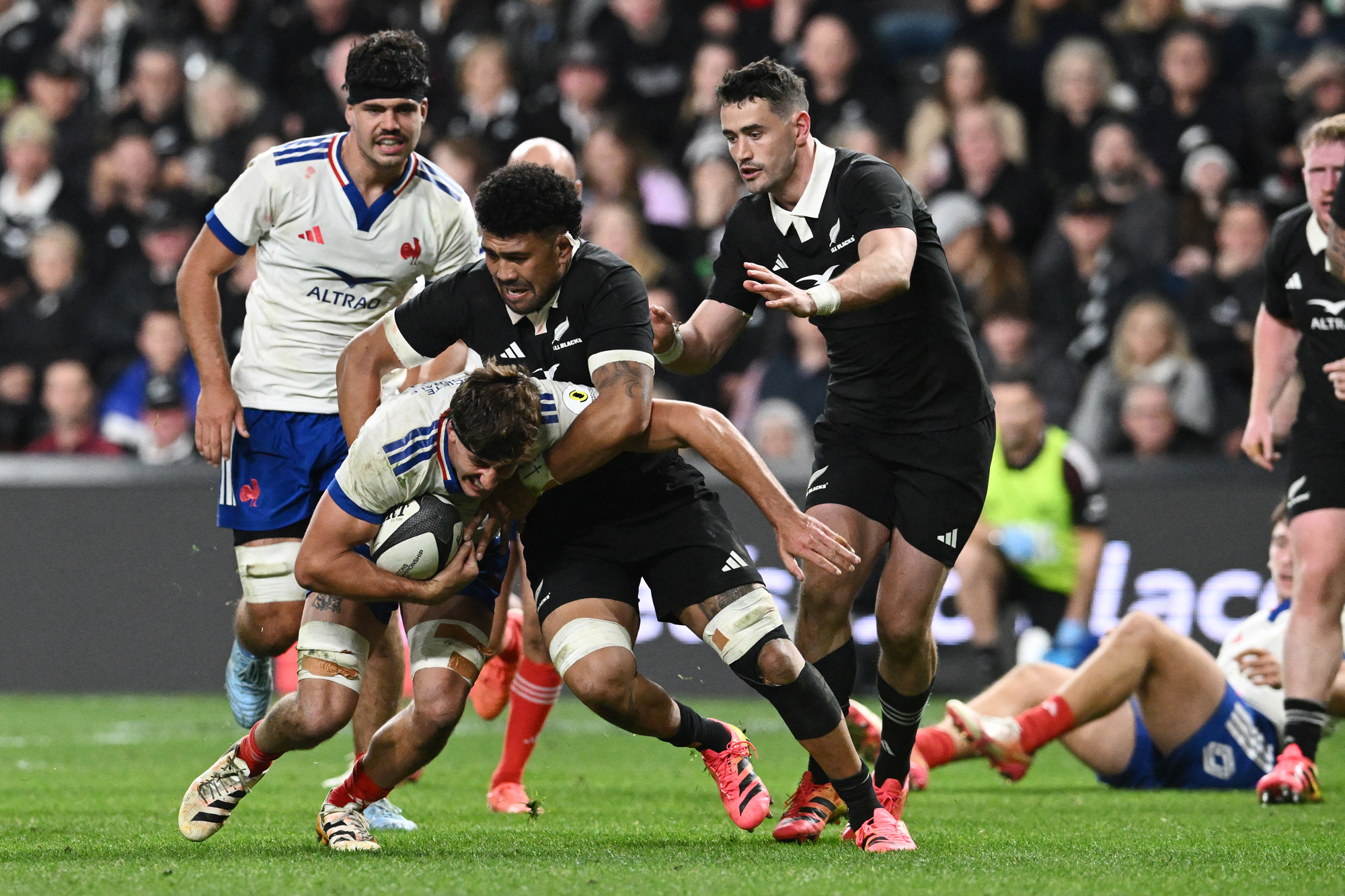 France's Oscar Jegou is tackled by New Zealand's Ardie Savea during the 2026 Nations Championship match