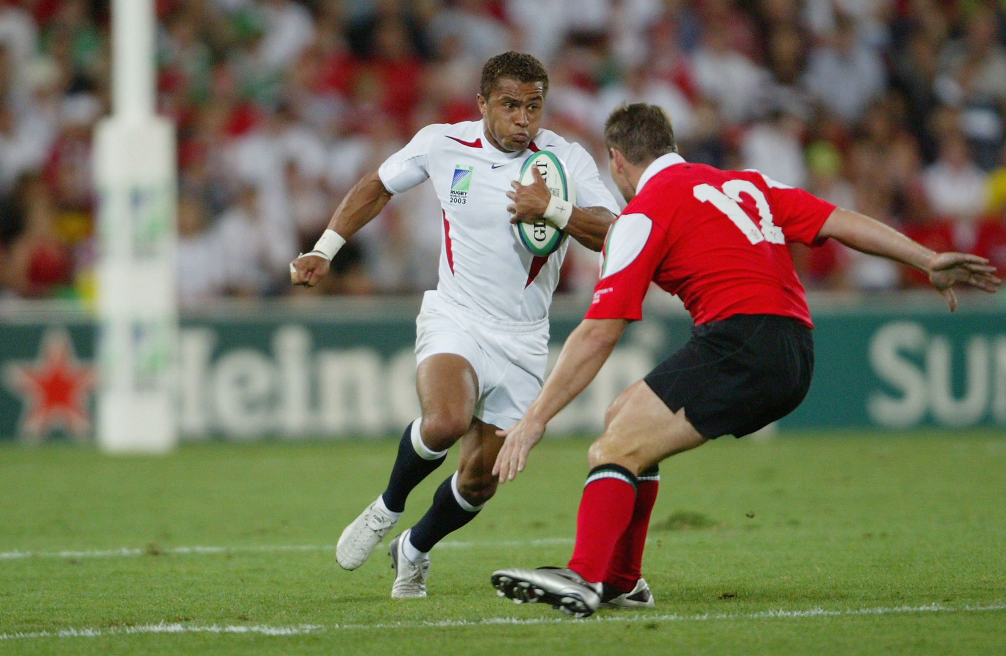 England’s Jason Robinson runs with the ball during the 2003 Rugby World Cup match against Wales