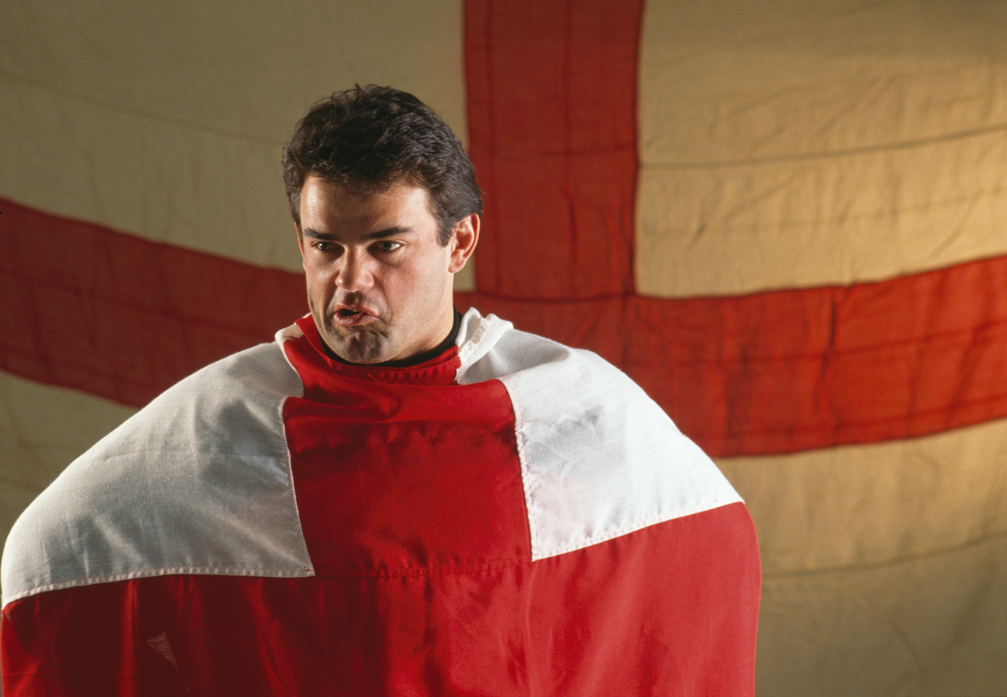 Will Carling is photographed wrapped in an England flag around 1990